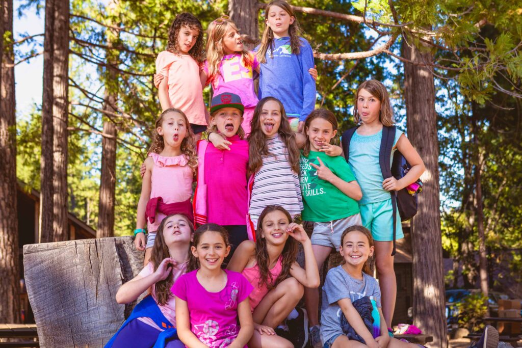 Group of campers in the forest sticking out tongues